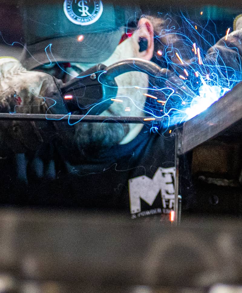 M3 employee operates a welder during metal fabrication