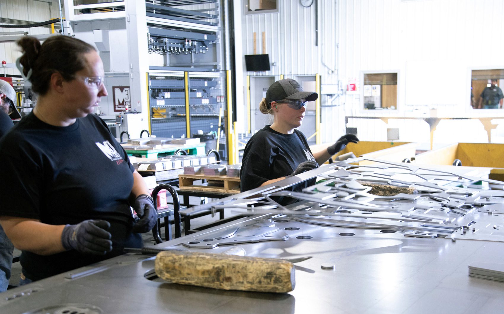 Workers employees at the shakeout area of m3 fabrication